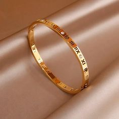 41136156082199 Gold Alloy Bangle Bracelet, Gold Party Bangle With Bracelet Strap, Gold Party Bangle, Adjustable Gold Alloy Bracelets, Gold Alloy Bracelets For Party, Gold Alloy Party Bracelets, Gold-colored Stainless Steel Wedding Bracelet, Dainty Gold Alloy Bracelet, Gold Metal Bangle For Anniversary