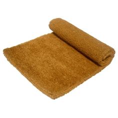 a rolled up brown towel on top of a white surface