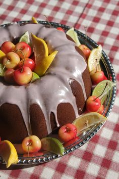 a bundt cake with icing and fruit on top