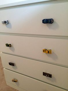 a white dresser with several drawers and knobs