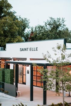 the entrance to saint ellee is lit up with lights and trees in the background