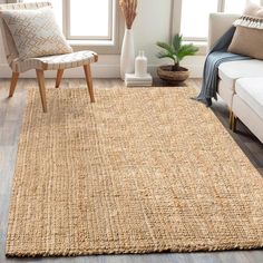 a living room with a couch, chair and rug