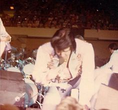 two men in white suits are playing drums