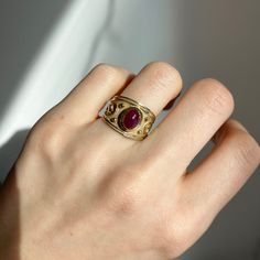 Estate/ vintage 14KT yellow Gold Byzantine/ Etruscan design polished + textured matte finish cigar band ring with genuine ruby. Elegant, old world piece with faceted, oval-shaped, cabochon, genuine red ruby. Ruby measures: 8mm x 5.7mm Size 7 Can be sized by your local jeweler or ours for a fee Solid Measures: 13.6mm wide~ graduated back to 3.5mm Weight: 4.6 grams Excellent condition Luxury Ruby Ring With Cabochon Cut, Yellow Gold Cabochon Ruby Ring, Luxury Ruby Ring Oval Cabochon, Luxury Ruby Oval Cabochon Ring, Luxury Ruby Ring With Oval Cabochon, Luxury Oval Ruby Birthstone Ring, Heirloom Style Ruby Ring, Luxury Ruby Ring Oval Cabochon Polished Finish, Luxury Ruby Ring Oval Cabochon With Polished Finish