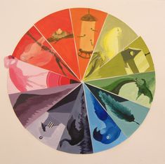 a colorful wheel with images of animals and birds on it's center circle, all in different colors