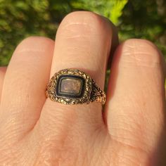 "A stunning Georgian era mourning ring in a rare state of complete preservation, with all the hallmarks, original inscription, enamel and hair. All in original condition. It has a central locket compartment glazed with its original rounded, beveled glass and accessible only by a jeweler. This has a black enamel inner bezel and an engraved gold outer bezel. The beautiful hand engraved detailing continues throughout the piece.  The back of the ring face is inscribed: \"James Slemeck Died 16 Feb\"y Heirloom Engraved Signet Ring For Memorial, Heirloom Memorial Engraved Signet Ring, Antique Yellow Gold Signet Ring With Black Enamel, Heirloom Engraved Ring With Intaglio For Collectors, Victorian 14k Gold Intaglio Engraved Ring, Victorian Enamel Ring For Anniversary, Victorian Black Enamel Anniversary Rings, Victorian Black Enamel Rings For Anniversary, Antique Oval Enamel Ring Collectible