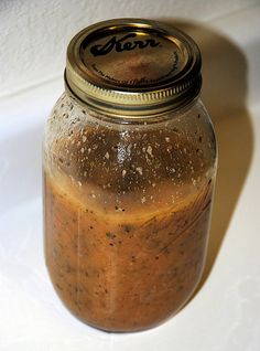 a glass jar filled with food sitting on top of a white tablecloth covered floor