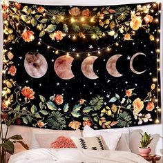 the moon and stars tapestry is hanging over a bed