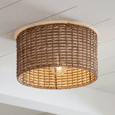 a wicker light fixture hanging from the ceiling