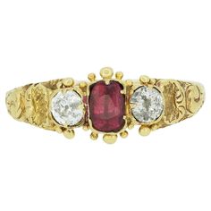 This is a wonderful 15ct yellow gold Georgian ring. The ring features a central rich red ruby with a bright white old cut diamond on each shoulder. The gemstones sit in closed back settings in a typical Georgian style and the ring features wonderful handcrafted detail. Condition: Used (Very Good) Weight: 1.3 grams UK Ring Size: P (56) Band Width: 1.65mm (at the back) - 7.25 (at front) Ruby: Approx. 0.25 carats Diamonds: Approx. 0.30 carats (0.15 carats each), Colour: G-H, Clarity: I1 Tested As: 15ct Gold Period: Late Georgian, Circa.1830s Box: Plain Gift Box Comments: These diamonds/gemstones have not been certified by a laboratory, they have been graded by our own qualified gemologists as fairly and as accurately as possible. Georgian Ring, Ruby And Diamond Ring, Ruby Diamond Rings, Ruby Diamond, Red Ruby, Wedding Attire, Diamond Gemstone, Bright White, Fashion Rings