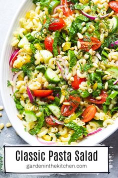 a white bowl filled with pasta salad on top of a table