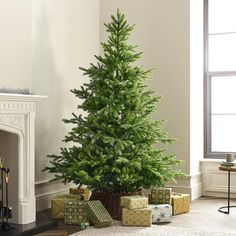 a christmas tree in a living room with presents under it