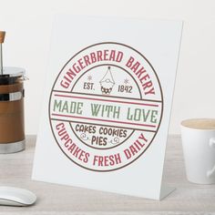 there is a sign that says made with love next to a cup and coffee mug