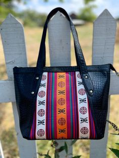 This bag was made by Tibetans in Northern India.  Brand Tenzing These bags are good quality and wrapped in real leather. Please consider supporting Himalayan handicraft artists through our shop! Artisan Multicolor Tote Bag, Multicolor Artisan Tote Bag, Traditional Leather Travel Bag, Artisan Multicolor Bag With Removable Pouch, Artisan Multicolor Shoulder Bag With Removable Pouch, Artisan Multicolor Bags With Removable Pouch, Artisan Multicolor Satchel Tote, Artisan Multicolor Tote Satchel, Artisan Multicolor Bag With Adjustable Strap