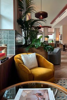 Golden velvet lounge chair underneath fringe chandelier lights in the lobby at the Hoxton Hotel in dowtown Los Angeles. Art Deco Boutique Hotel, Eclectic Hotel Lobby, Retro Hotel Lobby, Hotel Hoxton, Interior Design Classes, Velvet Lounge Chair, Los Angeles Interior Design