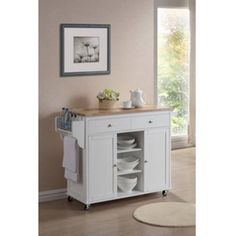 a white kitchen island with drawers and plates on it