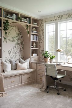 a home office with built in bookshelves, desk and window seat that has pillows on it