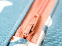 an open zipper on a blue and white fabric