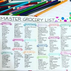 an open notebook with the words master grocery list on it and colored pencils next to it