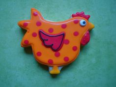 a cookie shaped like a chicken with polka dots on it