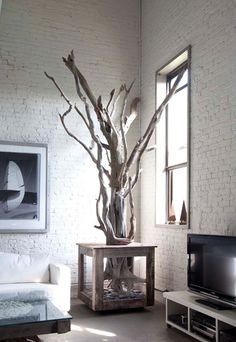 a living room filled with furniture and a flat screen tv sitting on top of a wooden table