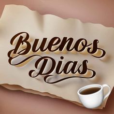 a piece of paper that says buenos dias next to a cup of coffee