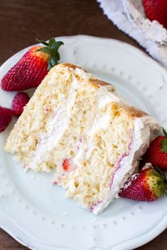 a piece of cake on a plate with strawberries