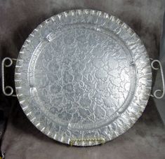 a silver plate sitting on top of a table