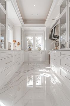 a white kitchen with marble flooring and cabinets