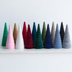 a row of colorful cones sitting on top of a white shelf