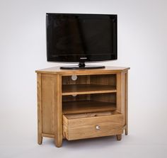 an entertainment center with a flat screen tv on it's stand and two drawers