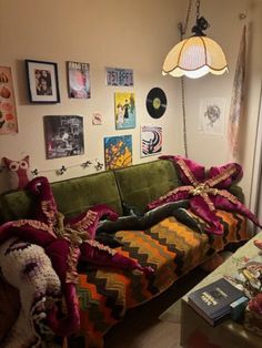 a living room filled with furniture and pictures on the wall