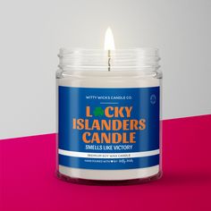 a candle that is on top of a pink and white surface with the words lucky islanders candle