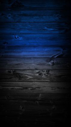 a dark wood floor with blue light coming from the top and bottom part of it