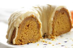 a bundt cake with white frosting and sprinkles on a plate