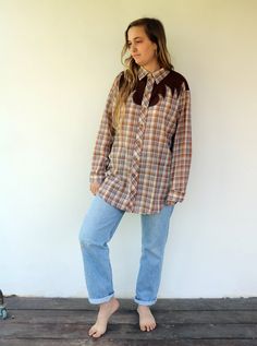 "Vintage western plaid blouse in brown with gold metallic threading, brown panels on both sides and on the upper back, snaps buttons down the front, original tag intact, cotton blend, aside from minor signs of wear, very good vintage condition. clean, ready to wear. ** Model is 5'7\" and size S/M for reference. Size labels state: Dress Tail 16-L-16 1/2 Approximate size: M/L - please refer to the measurements. M E A S U R E M E N T S -were taken with garments laying flat, please double where nece Brown Button-up Flannel Shirt For Fall, Brown Western Top With Buttons, Western Brown Tops With Buttons, Brown Western Style Top With Buttons, Western Style Brown Tops With Buttons, Brown Shirt With Button Closure For Daywear, Brown Flannel Workwear Shirt, Brown Buttoned Flannel Shirt For Work, Brown Rodeo Shirt With Button Closure