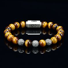 Genuine Tiger Eye Bead Bracelet for Men or Women Blue Steel Cable Custom Silver Magnetic Clasp Custom Silver Beads 10mm - AAA Quality Tiger Eye Premium Bead Bracelet with round 10 millimeter blue tigers eye beads, silver logo beads combined with a silver logo magnetic clasp. Comes with a premium leather logo box. You will not find the quality of beads I use which are 5A quality rated, the custom silver beads and high quality custom made silver clasp I use for my bracelets at any where close to t Luxury Round Gemstone Bead Bracelets, Luxury Round Gemstone Beaded Bracelets, Luxury Round Gemstone Beads Bracelet, Luxury Beaded Bracelets With Natural Stones, Luxury Rondelle Bracelets With Polished Beads, Luxury 8mm Beaded Bracelets, Luxury Polished Rondelle Beads Bracelets, Luxury Silver Bracelets With Gemstone Beads, Luxury Beaded Bracelets With 8mm Beads