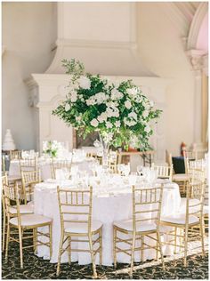 the tables are set with white linens and gold chairs for an elegant wedding reception