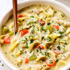 a white bowl filled with pasta and vegetables