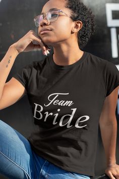 "Embrace wedding camaraderie with our spirited collection, merging playful energy and comfort. This ensemble celebrates the excitement of ""Team Bride"" and ""Team Groom,"" fostering a sense of unity and anticipation as you embark on this joyous journey together. Made to feel like a well-loved favorite, these tees come with a feminine fit that is as stylish as it is comfy. The ribbed knitting makes the collar highly elastic while the twill tape on the shoulder seams stabilizes the back of the sh Cards Against Humanity Bridal Shirts, Team Groom, Trendy Bride, Wedding Party Shirts, Bride Shirt, Bride Shirts, Bachelorette Party Shirts, Womens Shirt, Team Bride