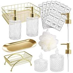 gold bathroom accessories including soap dispenser, toothbrush holder and glassware