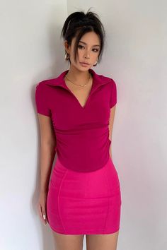 a woman in a pink dress posing for the camera