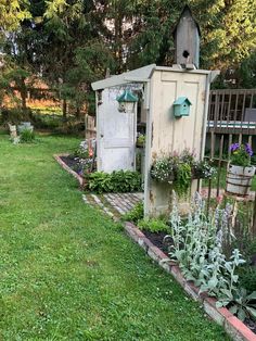 an outhouse in the middle of a garden