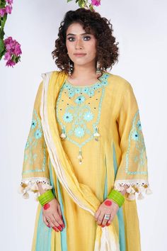 Yellow tunic with panels and floral thread embroidery. Comes with salwar, dupatta and inner.
Components: 4
Pattern: Embroidered
Type Of Work: Thread,Pearl
Neckline: Round
Sleeve Type: Three quarter
Fabric: Pure Mul Chanderi with cotton fabric
Color: Yellow
Other Details: 
Length:
Tunic: 40 inch
Salwar: 37 inch
 Dupatta (LxW):40 inchx2.5 mtr
Model Height: 5 ft 3 Inches wearing size 10
Occasion: Mehendi and Haldi - Aza Fashions Unstitched Straight Kurta Palazzo Set With Gota Work, Yellow Mulmul Sharara With Dupatta, Yellow Traditional Wear With Dupatta In Mulmul, Yellow Mulmul Traditional Wear With Dupatta, Designer Sharara With Zari Work In Cambric, Unstitched Yellow Mulmul Sharara, Yellow Palazzo Set With Dabka Work In Mulmul, Yellow Unstitched Mulmul Sharara, Yellow Mulmul Palazzo Set With Dabka Work