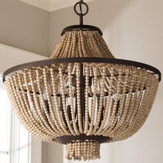 a chandelier made out of beads hanging from a ceiling fixture in a room