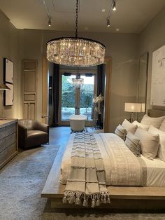 a large bedroom with a chandelier hanging from the ceiling