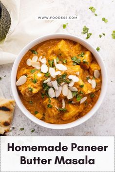 homemade paneer butter masala with almonds and cilantro in a white bowl