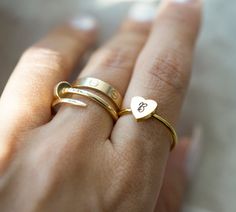 "Introducing our exquisite Personalized Initial Heart Ring, a symbol of love and individuality. Crafted with precision and passion, this stunning piece is a true embodiment of elegance and sentiment. Its delicate heart-shaped design is adorned with your chosen initials, making it a truly unique and meaningful accessory. Each item is made-to-order, which gives our pieces a unique meaning that is specific and special to you. H O W ∙ T O ∙ O R D E R It's easy as 1, 2, 3! 1. Select options from the Unique Meaning, Engraved Cuff, Jewelry Birthday, Initial Ring, Custom Initials, Birthday Jewelry Gift, Stackable Ring, Anniversary Gift For Her, Love Symbols