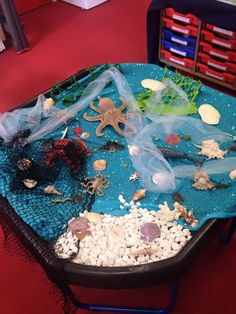 an ocean themed play table with sea animals and rocks