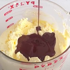 a mixing bowl filled with batter and chocolate